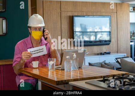 Concept of coronavirus quarantine. Man with a medical face mask using the phone to search for a Job. Stock Photo