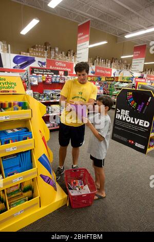 Eighteen year old college freshmans, takes 8 year old brother shopping for school supplies at an office supply store in Texas. Model Released   2012. ©Marjorie Kamys Cotera / Daemmrich Photos