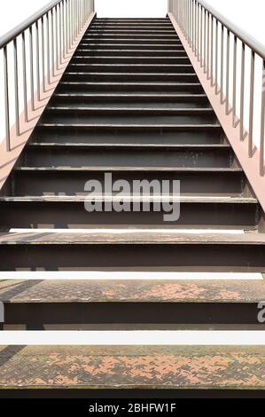metal rusty old staircase with railing. isilated on white background Stock Photo