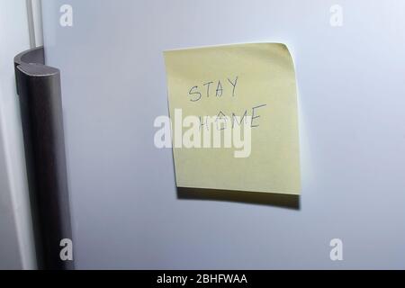 sheet of paper that says stay at home Stock Photo