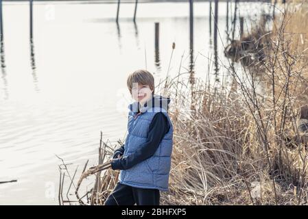 Portrait of a teen boy in front of a lake Stock Photo