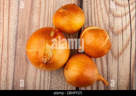 Juicy ripe onions on a wooden background. Close up Stock Photo