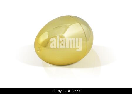 Shiny golden egg perched luxuriously on a white background. Contains a clipping path around the egg. Stock Photo