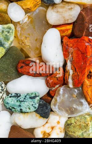 close up of a bunch of small naturally polished stones found in the Oregon coast in a variety of bright colors and shapes Stock Photo