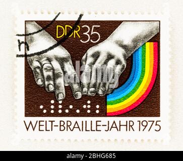 SEATTLE WASHINGTON - April 25, 2020: Postage featuring fingers reading braille and rainbow commemorating 1975 International Braille Year. Scott # 1691