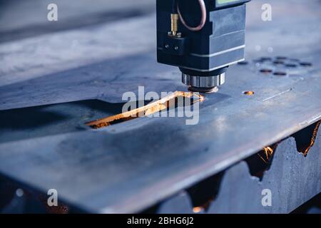 CNC gas cutting metal sheet, sparks fly. Blue steel color, modern industrial technology Stock Photo