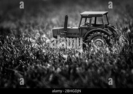 toy farm tractor on grass Stock Photo