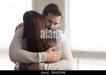 Handsome man embracing woman calms in difficult moment. Stock Photo