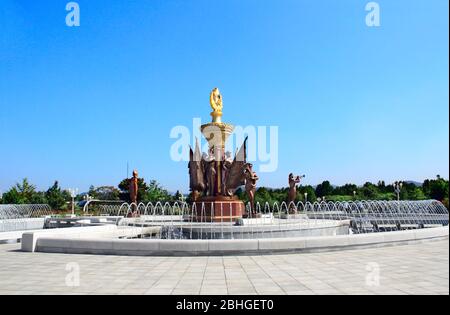 NORTH KOREA, PYONGYANG - SEPTEMBER 27, 2017: Fountain with sculptures of sentries with flags and musicians in park of Kumsusan Memorial Palace of the Stock Photo