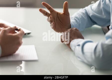 Close up diverse businessman hands talking at meeting. Stock Photo