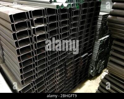 Pile of balck metal bars with different size Stock Photo