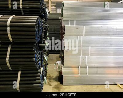 Pile of balck metal bars with different size Stock Photo