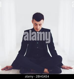 portrait of young handsome man sitting on the floor Stock Photo