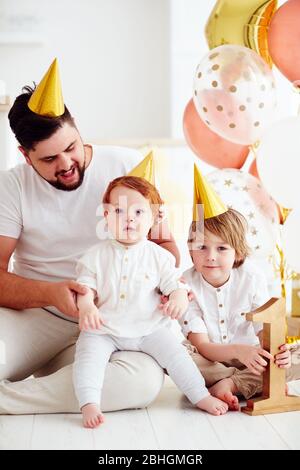 portrait of happy family celebrating infant baby boy's 1st birthday party Stock Photo