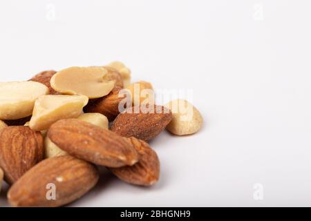 Healthy nuts on White Background. Nuts are a snack food consisting of any mixture of mechanically or manually combined nuts. Stock Photo