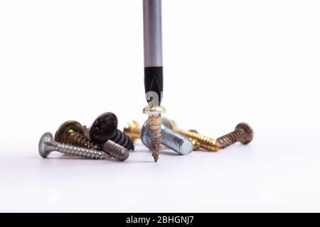 different set of screws and screwdriver on white background Stock Photo