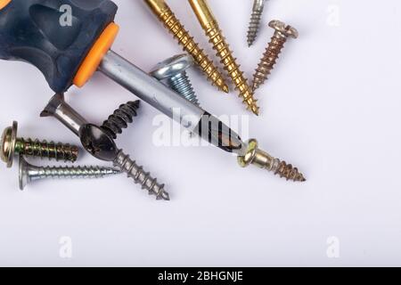 different set of screws and screwdriver on white background Stock Photo