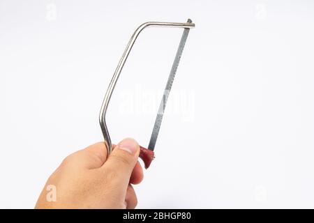 Man hand with Junior Hacksaw on a white background Stock Photo