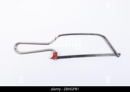 Man hand with Junior Hacksaw on a white background Stock Photo