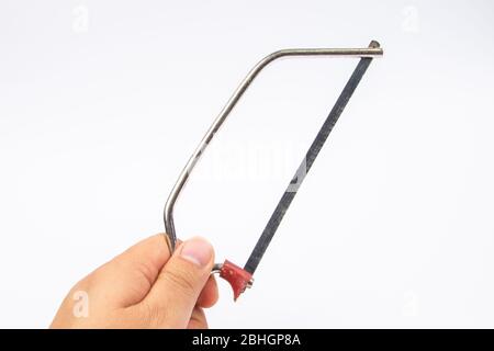 Man hand with Junior Hacksaw on a white background Stock Photo