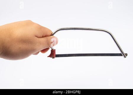 Man hand with Junior Hacksaw on a white background Stock Photo