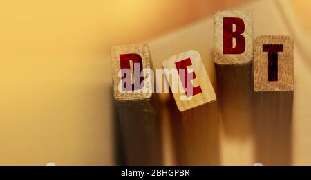 DEBT word made with wooden blocks. Liability unprofitable business or personal loss concept Stock Photo