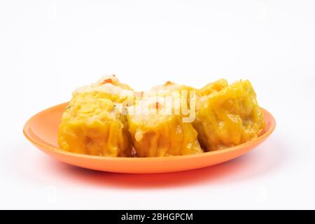 Siu Mai - Chinese steamed pork dumplings on plate isolated on white background. Stock Photo