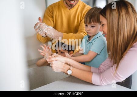 Kid washing hands with alcohol gel or antibacterial soap sanitizer ...