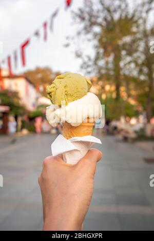 Turkish ice cream Dondurma in hand on the background of the Kas town Stock Photo