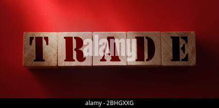 Trade word on Wooden cubes on red. Business deals Concept Stock Photo