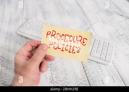 Conceptual hand writing showing Procedure Policies. Concept meaning Steps to Guiding Principles Rules and Regulations Man holding colorful reminder sq Stock Photo