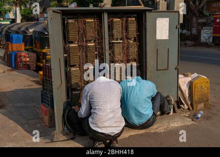 Mumbai / India 26 March 2020 Two Technicians of Mahanagar Telephone Nigam Ltd (MTNL) check telephone exchange equipment at goregaon Mumbai Maharashtra Stock Photo