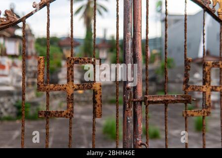 Rusted Hindu Swastika on Fence in Bali Stock Photo