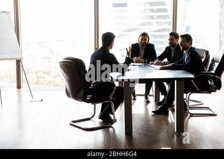 Happy colleagues having fun at meeting in boardroom Stock Photo