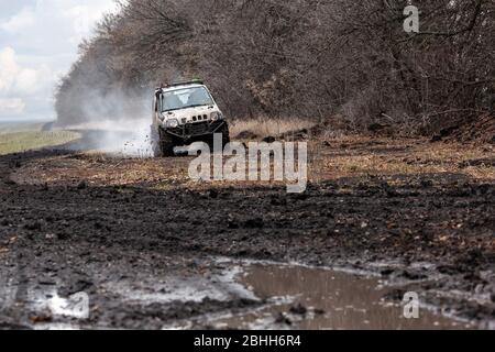 Off road car is driving on a bad dirty road. Stock Photo