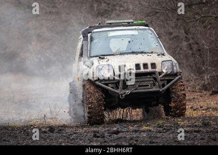 Off road car is driving on a bad dirty road. Stock Photo