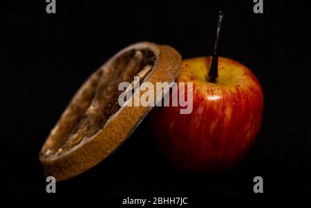 small apple and slice of lemon on black background Stock Photo