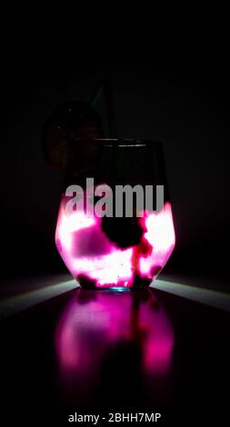 blueberry juice with ice cubes, back light, dark Stock Photo