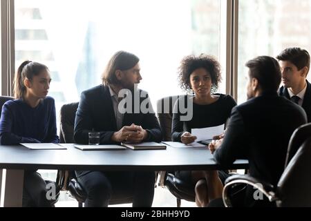 Confident African American hr manager asking questions to candidate Stock Photo