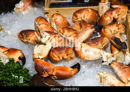 Crab claws on ice for sale at the fish market Stock Photo