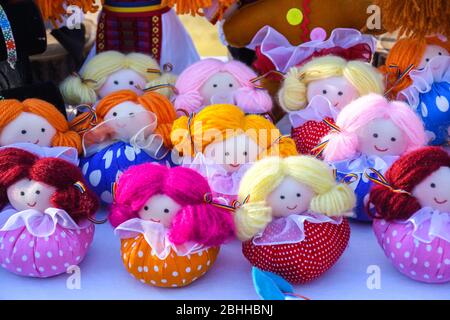 Stuffed dolls dressed in traditional Romanian clothing. Beautiful handmade handicraft, artisan decorative gift or souvenir for friendship kids, childr Stock Photo