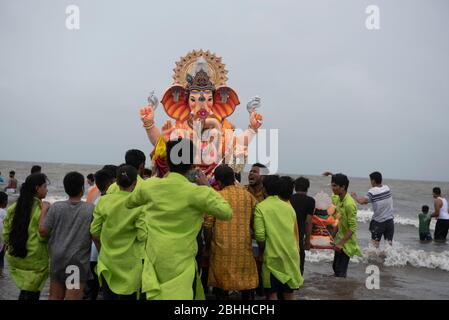 Mumbai / India 12 September 2019 People carrying Lord Ganesh idol for immersion in the Sea at Juhu Beach Mumbai Maharashtra India Stock Photo