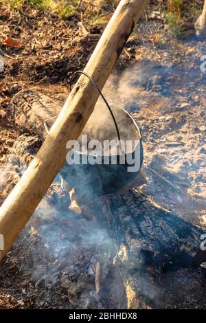 Cauldron or Camping Kettle Over Open Fire Outdoors Stock Image