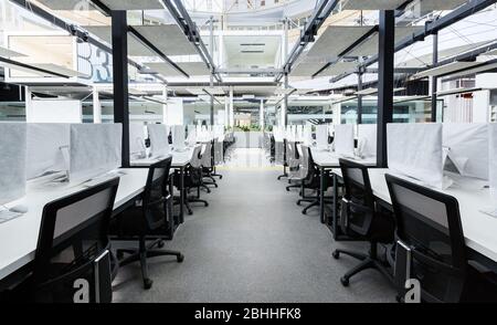 Co-working space with modern computers hiding by covers Stock Photo