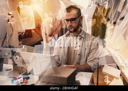 Seamstress works to new clothes ordered by internet client Stock Photo