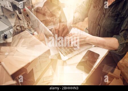 Seamstress works to new clothes ordered by internet client Stock Photo