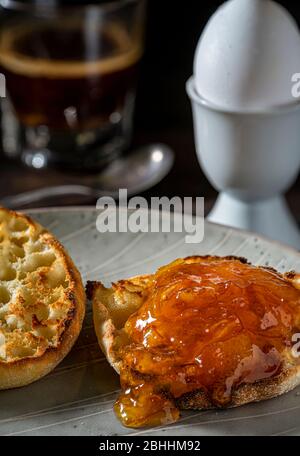 Orange marmalade on toasted English muffin. Stock Photo