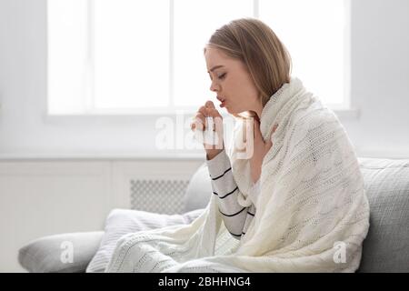 Sick young woman coughing at home, empty space Stock Photo