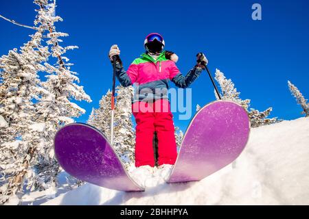 Skier skiing downhill in high mountains winter forest Stock Photo