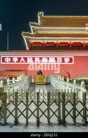 02 January 2020, Beijing China: A policeman is looking the crown out of the Gate of Heavenly Peace during the night Stock Photo